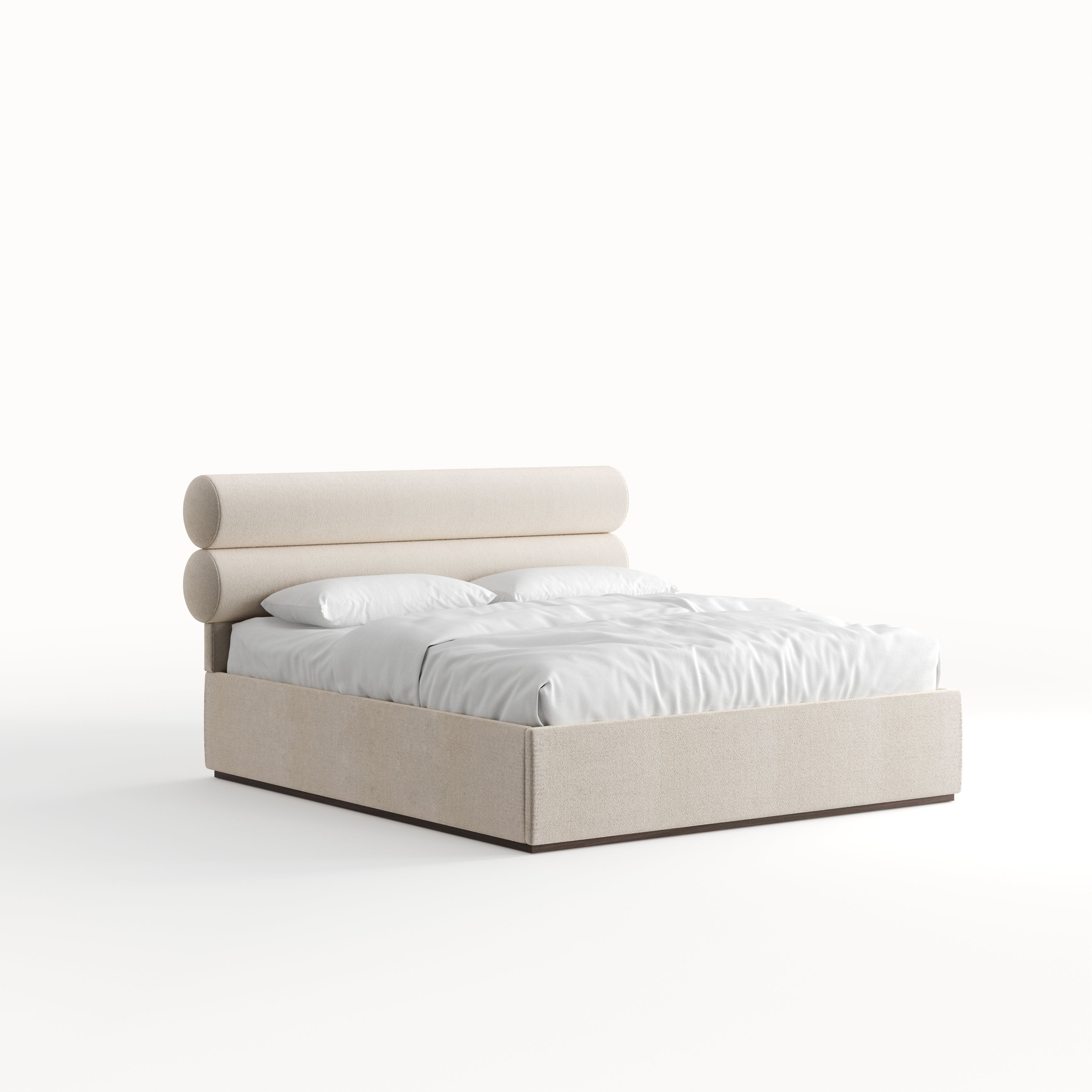 A beige upholstered bed with a padded headboard and a white mattress, designed with a Mid-Century aesthetic for an apartment at The OWO