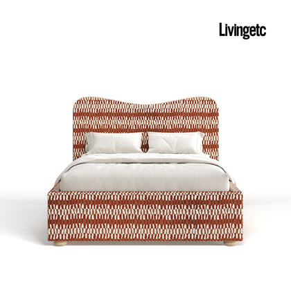 Bed with red and white patterned headboard and bedding on a white background