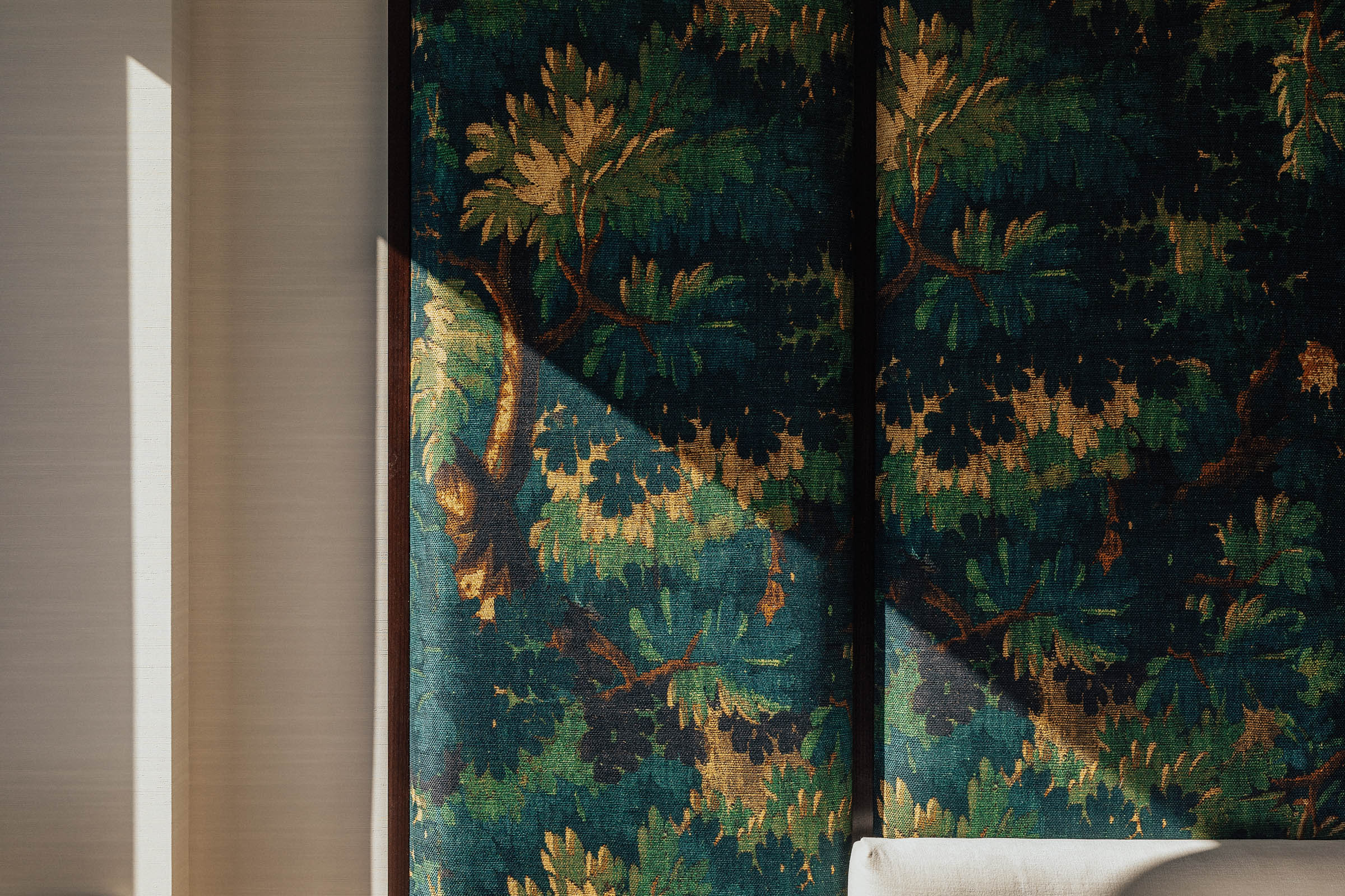 Close up of oversized decorative headboard panel. forest-themed wall.