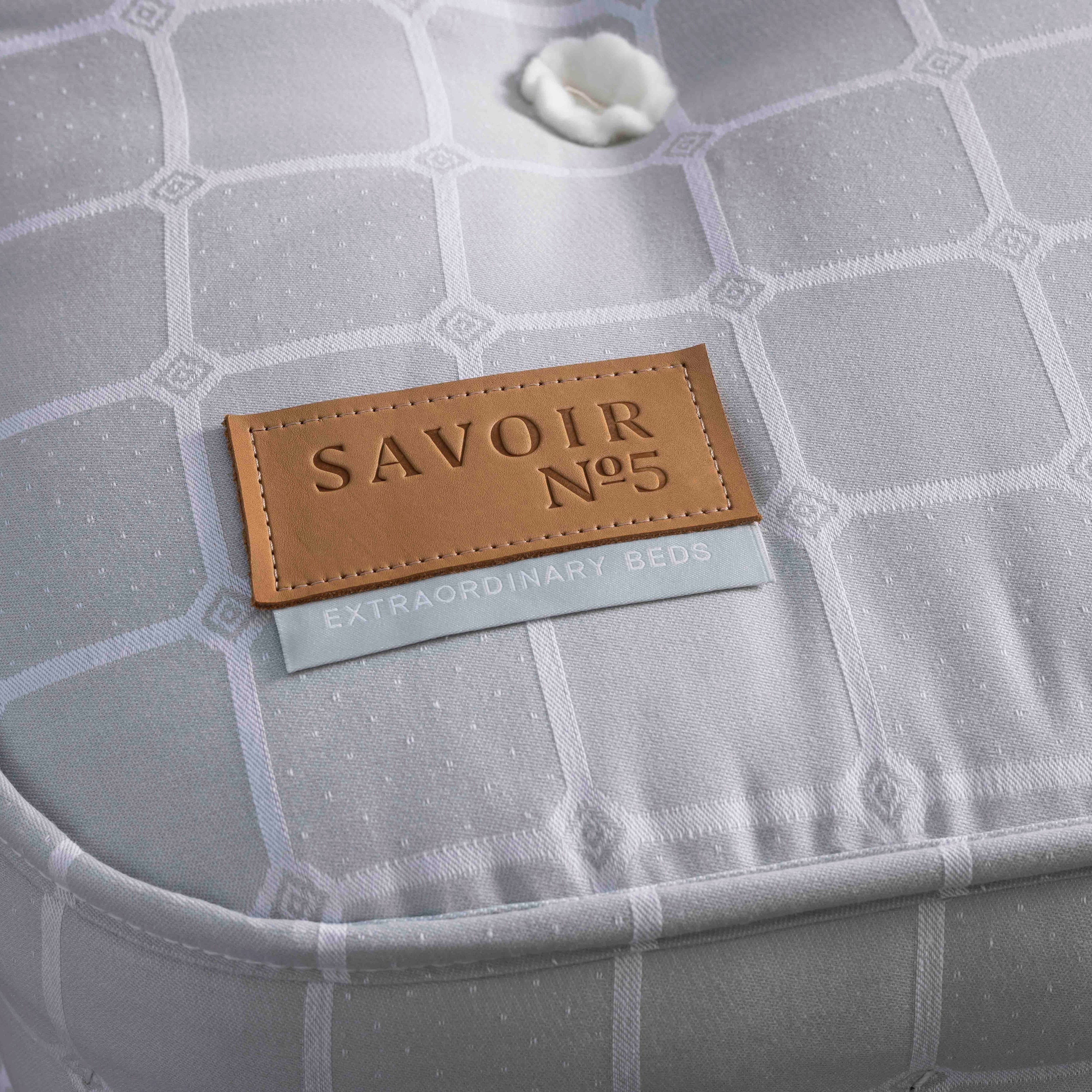 Gray textured product with a brown 'SAVOIR No.5' label on a dark background